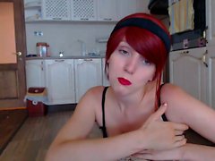 Buxom young redhead loses her tight panties and fingers her