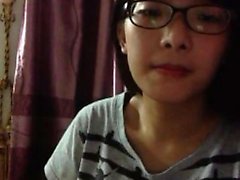 Nerdy young cock-lover takes her top off and teases the cam