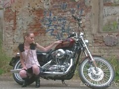 Cute teen is amazed by a big bike