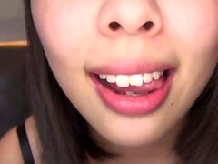 Asian bimbo sucks on a big cock close up